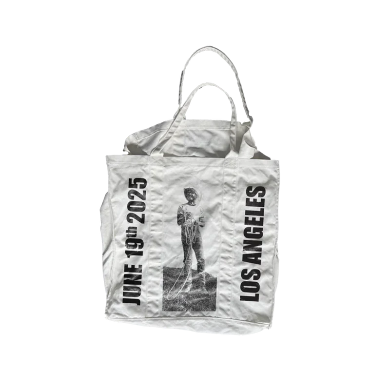 Natural canvas Post Malone LA tour tote with a black and white cowboy statue photo and Los Angeles text