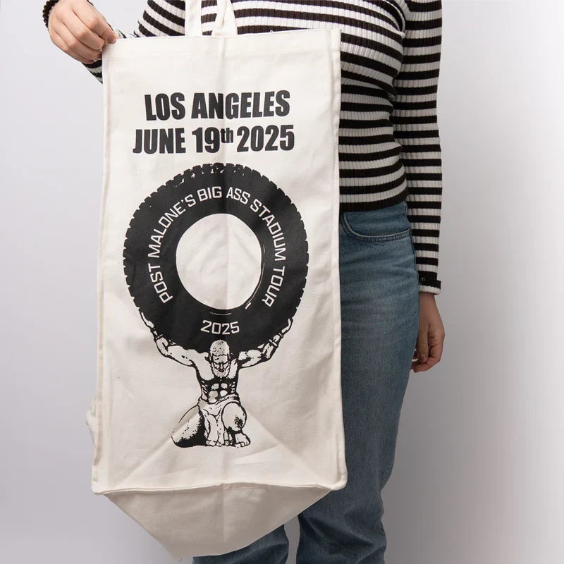Natural canvas Post Malone LA tour tote with a black tire graphic and Big Ass Stadium Tour lettering